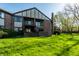 Brick two-story home featuring a private patio on the ground floor and balconies on the second story overlooking a lush green yard at 2141 Rome Dr # Apt B, Indianapolis, IN 46228