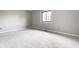 Neutral bedroom with carpeted floors, light gray walls, and a window at 2141 Rome Dr # Apt B, Indianapolis, IN 46228
