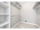 Walk-in closet with carpet and white storage shelves and clothes racks at 2141 Rome Dr # Apt B, Indianapolis, IN 46228