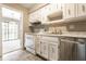 Traditional kitchen with stainless steel appliances, tile floors, and white cabinets and countertops at 2141 Rome Dr # Apt B, Indianapolis, IN 46228