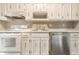 Traditional kitchen with stainless steel appliances, tile floors, and white cabinets and countertops at 2141 Rome Dr # Apt B, Indianapolis, IN 46228