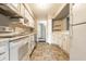 Traditional kitchen with stainless steel appliances, tile floors, and white cabinets and countertops at 2141 Rome Dr # Apt B, Indianapolis, IN 46228