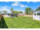 Spacious backyard featuring a detached garage, fire pit and a well-maintained lawn, perfect for outdoor activities at 222 Raines St, Plainfield, IN 46168