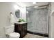Bathroom with black and white marble tile, frameless shower door, and modern vanity at 222 Raines St, Plainfield, IN 46168
