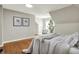 Bedroom featuring sloped ceilings, hardwood floors, a queen size bed, and sitting chair at 222 Raines St, Plainfield, IN 46168