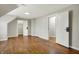Open bedroom with hardwood floors, neutral walls, and views of adjacent rooms at 222 Raines St, Plainfield, IN 46168