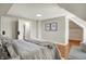 Bedroom featuring sloped ceilings, hardwood floors, a queen size bed, and access to attic storage at 222 Raines St, Plainfield, IN 46168