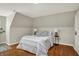 Bedroom with sloped ceilings, hardwood floors, a queen size bed, and two side tables at 222 Raines St, Plainfield, IN 46168