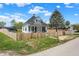 Charming two-story home with white siding, blue shutters, covered front porch and fenced yard at 222 Raines St, Plainfield, IN 46168