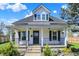 Charming two-story home with white siding, black accents, covered front porch and well maintained landscaping at 222 Raines St, Plainfield, IN 46168
