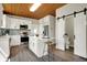 Open kitchen with stainless steel appliances, an island with seating, and a sliding barn door at 222 Raines St, Plainfield, IN 46168