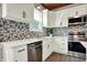 Modern kitchen with stainless steel appliances, mosaic backsplash, and white countertops at 222 Raines St, Plainfield, IN 46168
