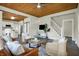 Open-concept living room featuring hardwood floors, wood ceiling, neutral decor, and easy access to the kitchen at 222 Raines St, Plainfield, IN 46168