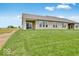 Backyard with spacious lawn and the back of the home with multiple windows at 2249 Aviary Ln, Danville, IN 46122