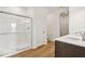 Bathroom features a glass-enclosed shower, white cabinets and wood floors at 2249 Aviary Ln, Danville, IN 46122