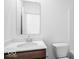 Well-lit bathroom with white sink, wood cabinet and white toilet at 2249 Aviary Ln, Danville, IN 46122