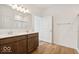 Bathroom features double sinks, wood cabinets, wood floor and glass-enclosed shower at 2249 Aviary Ln, Danville, IN 46122