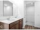 Bathroom with double sinks, wood-look floor, linen closet behind, and spacious mirror at 2249 Aviary Ln, Danville, IN 46122