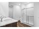 Bright bathroom featuring a glass-enclosed shower, double sink vanity, and a neutral color scheme at 2249 Aviary Ln, Danville, IN 46122