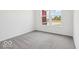 Bedroom with neutral carpet, a large window, and white walls at 2249 Aviary Ln, Danville, IN 46122