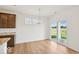 Dining area with wood floors, sliding glass doors to patio and modern light fixture at 2249 Aviary Ln, Danville, IN 46122