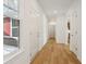 Hallway with hardwood floors, white walls, white trim, and natural light at 2249 Aviary Ln, Danville, IN 46122