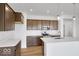 Stylish kitchen featuring stainless steel appliances, dark wood cabinets, and a white center island at 2249 Aviary Ln, Danville, IN 46122