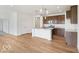 Open concept kitchen with island, stainless steel appliances, and wooden floors and cabinets at 2249 Aviary Ln, Danville, IN 46122