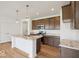 Beautiful kitchen features an island, granite countertops, stainless appliances and wooden cabinets at 2249 Aviary Ln, Danville, IN 46122