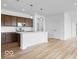 Modern kitchen featuring a white center island, stainless steel appliances, and dark wood cabinets at 2249 Aviary Ln, Danville, IN 46122