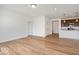 Living Room with an open concept view into the kitchen area, white walls, and wood flooring at 2249 Aviary Ln, Danville, IN 46122