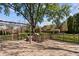 Backyard deck featuring seating, grill, lush lawn, landscaping, and mature trees providing shade and privacy at 2253 Mullinix Rd, Greenwood, IN 46143