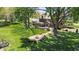 Backyard featuring a fire pit, spacious lawn, and mature trees providing ample shade at 2253 Mullinix Rd, Greenwood, IN 46143