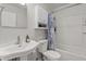 This well-lit bathroom features a stylish sink and toilet, plus shower with curtain at 2253 Mullinix Rd, Greenwood, IN 46143