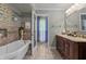 Detailed bathroom boasting soaker tub, tile accents, and double vanity at 2253 Mullinix Rd, Greenwood, IN 46143
