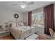 Cozy bedroom showcases ample natural light, ceiling fan, and a decorative wrought iron bed frame at 2253 Mullinix Rd, Greenwood, IN 46143