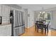 Bright dining area with hardwood floors, modern lighting and a view to the exterior at 2253 Mullinix Rd, Greenwood, IN 46143