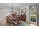 Elegant dining room with wooden table, chandelier, and large windows at 2253 Mullinix Rd, Greenwood, IN 46143