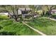 Aerial view of home featuring a sprawling green lawn, mature trees, and a charming garden path at 2253 Mullinix Rd, Greenwood, IN 46143