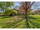 Lovely front yard view of a brick home with large trees providing ample shade on a sunny day at 2253 Mullinix Rd, Greenwood, IN 46143