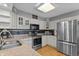 Well-lit kitchen featuring stainless steel appliances, granite countertops, and ample cabinet space at 2253 Mullinix Rd, Greenwood, IN 46143