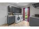 Well-lit laundry room with modern washer and dryer and cabinet storage at 2253 Mullinix Rd, Greenwood, IN 46143