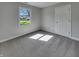 Bright bedroom featuring neutral walls and carpet and a large window, creating a calming space at 2338 Keystone Ct, Anderson, IN 46011
