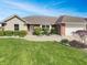 Charming single-story home with a well-manicured lawn, landscaped bushes, and a two car garage at 2338 Keystone Ct, Anderson, IN 46011