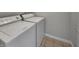 Well-lit laundry room features modern appliances with tile floors for convenient laundry at 2338 Keystone Ct, Anderson, IN 46011