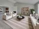 Bright living room featuring modern furniture, vaulted ceilings, a fireplace, and an open floor plan at 2338 Keystone Ct, Anderson, IN 46011