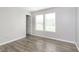 Bedroom featuring neutral walls, two windows, and wood-look floors at 2348 Shadowbrook Dr, Plainfield, IN 46168