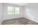 Bedroom featuring neutral walls, two windows, and wood-look floors at 2348 Shadowbrook Dr, Plainfield, IN 46168