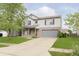 Two-story home with light gray siding, brick accents, and a two-car garage at 2348 Shadowbrook Dr, Plainfield, IN 46168