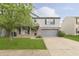 Two-story home with light gray siding, brick accents, two car garage at 2348 Shadowbrook Dr, Plainfield, IN 46168